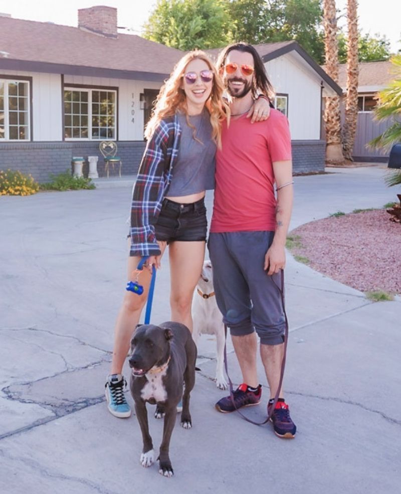 Lesley Logan - Author, Mindset Coach, and Fitness Guru with her husband Brad Crowell walking around the neighborhood with their dogs